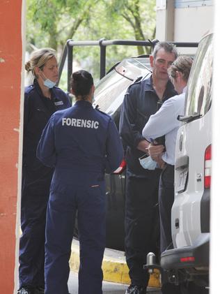 Forensic police outside the flats.