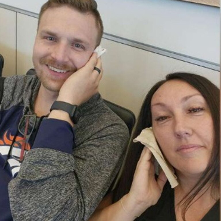 Jaci Purser and another passenger hold a cloth on their ears on board a flight that had cabin pressurisation issues. She said she felt her ear pop from the pressure in the cabin before it started bleeding. Picture: KLS