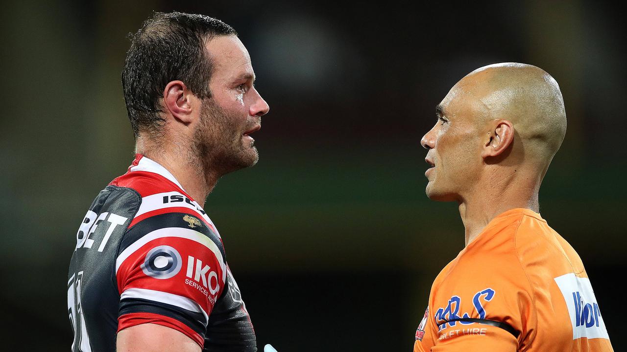 Roosters captain Boyd Cordner in the hands of the trainer after his latest head knock.