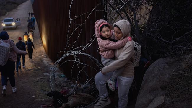 Migrants cross through a gap in the US-Mexico border fence in Jacumba Hot Springs, San Diego, California. Picture: Getty