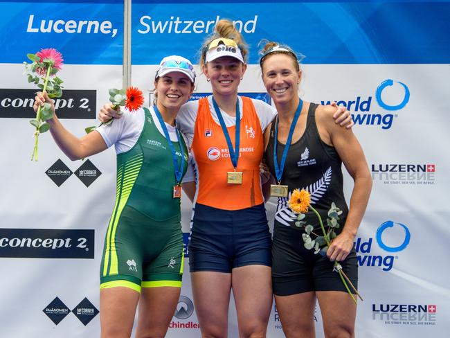 Tara Rigney celebrates on the podium. Picture: Rowing Australia