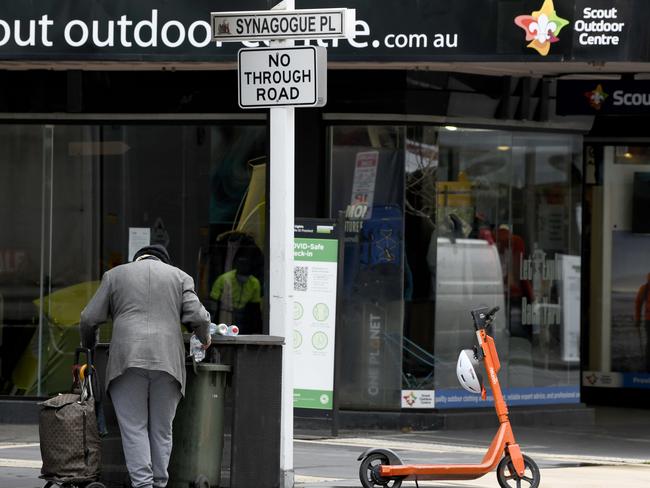 A man retrieves empty bottles from a bin on Rundle Street on Thursday, July 22.. Picture: NCA NewsWire / Naomi Jellicoe