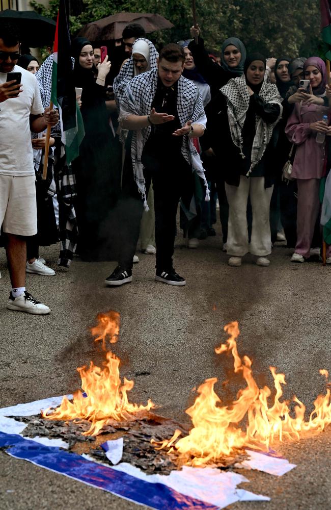 Students set fire to an Israeli flag during a pro-Palestinian demonstration in the Lebanese American University in Beirut. Picture: AFP