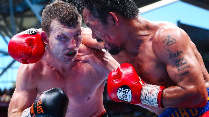 CORRECTION - Manny Pacquiao (R) of the Philippines fights Jeff Horn (L) of Australia during the World Boxing Organization boat at Suncorp Stadium in Brisbane on July 2, 2017.  / AFP PHOTO / Patrick HAMILTON / -- IMAGE RESTRICTED TO EDITORIAL USE - STRICTLY NO COMMERCIAL USE -- / “The erroneous mention[s] appearing in the metadata of this photo by Patrick HAMILTON has been modified in AFP systems in the following manner: [July 2] instead of [July 1]. Please immediately remove the erroneous mention[s] from all your online services and delete it (them) from your servers. If you have been authorized by AFP to distribute it (them) to third parties, please ensure that the same actions are carried out by them. Failure to promptly comply with these instructions will entail liability on your part for any continued or post notification usage. Therefore we thank you very much for all your attention and prompt action. We are sorry for the inconvenience this notification may cause and remain at your disposal for any further information you may require.”