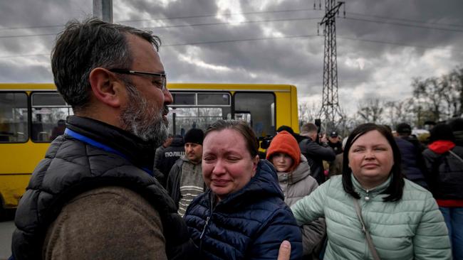 People fleeing fighting Mariupol meet with relatives and friends as they arrive in a small convoy that crossed through territory held by Russian forces. Picture: AFP.