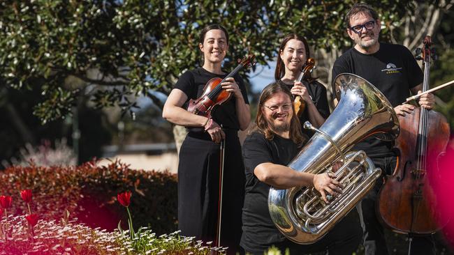 Queensland Symphony Orchestra musicians (from left) Sonia Wilson, Thomas Allely, Ceridwen Jones and Craig Allister Young as the orchestra prepares for an open air concert in Queens Park for Carnival of Flowers, Friday, September 6, 2024. Picture: Kevin Farmer