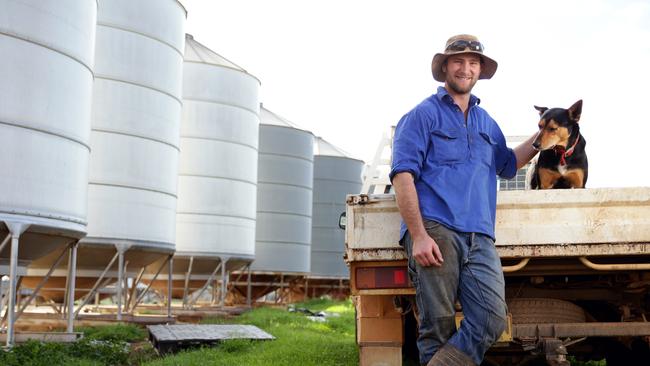 Farmer Dan Fox with his dog Batman on his farm at Marrar in southern NSW. Picture: Jonathan Ng