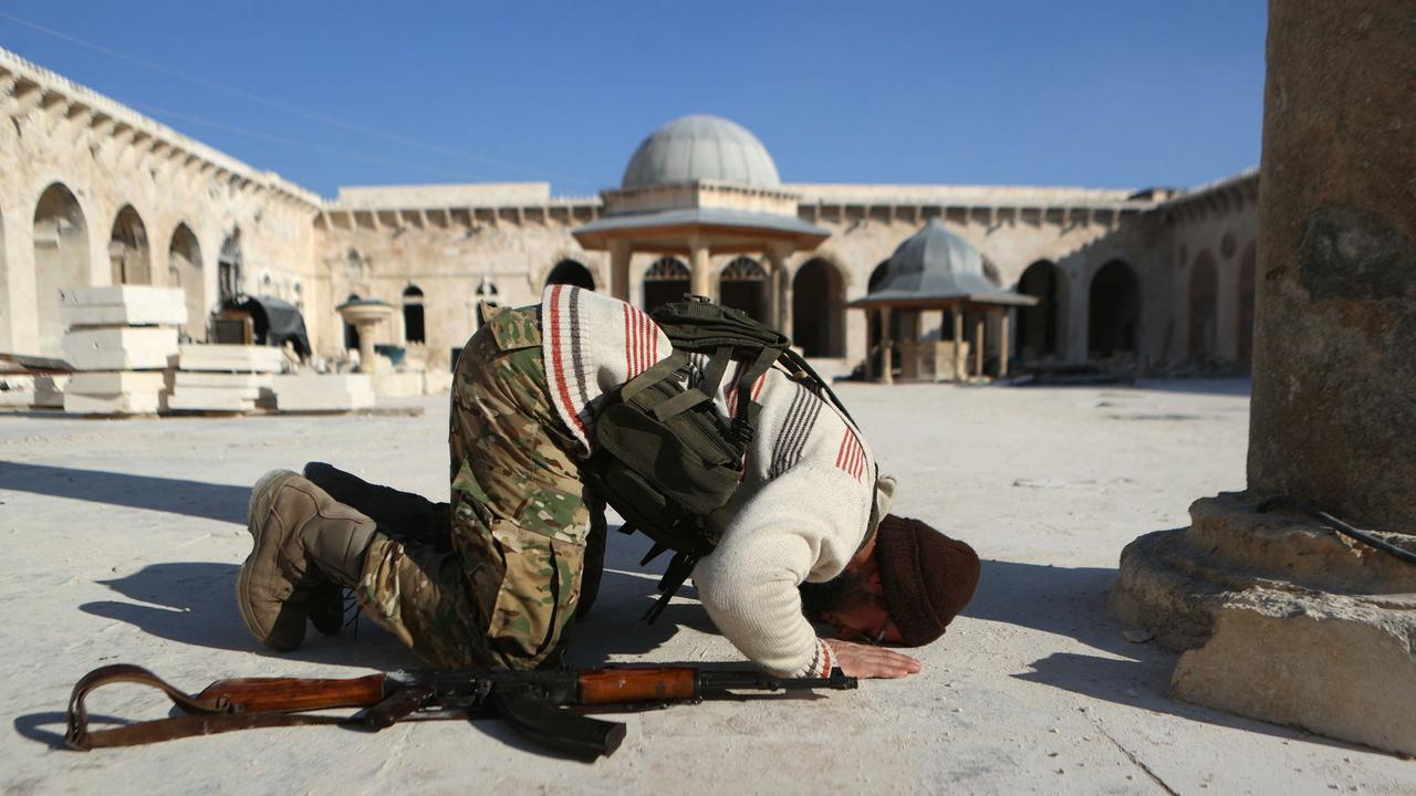 An anti-government fighter kneels in prayer inside the 8th-century Umayyad Mosque in Aleppo on November 30, 2024. Picture: AFP