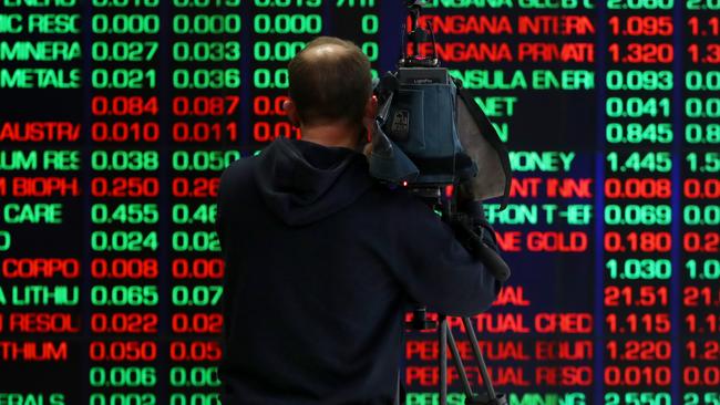 SYDNEY, AUSTRALIA - AUGUST 06: A TV camera person records electronic boards displaying stock information at the Australian Securities Exchange, operated by ASX Ltd. on August 06, 2024 in Sydney, Australia. The markets are closely attuned to the RBA's next rates decision, with inflation persisting even as rates have been elevated for an extended time after the end of the COVID-19 pandemic. (Photo by Lisa Maree Williams/Getty Images)