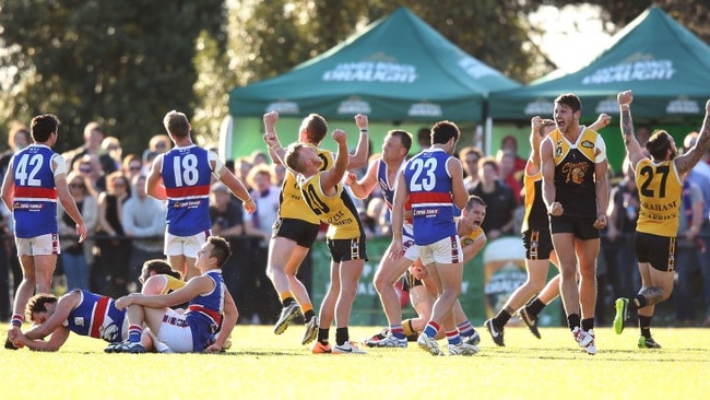 MELBOURNE, AUSTRALIA - SEPTEMBER 21:  YCW players celebrate the win on the final siren during the Peninsula Football Netball League Grand Final match between the Mornington Bulldogs and the Frankston YCW at Frankston Park on September 21, 2014 in Melbourne, Australia.  (Photo by Michael Dodge/Getty Images)