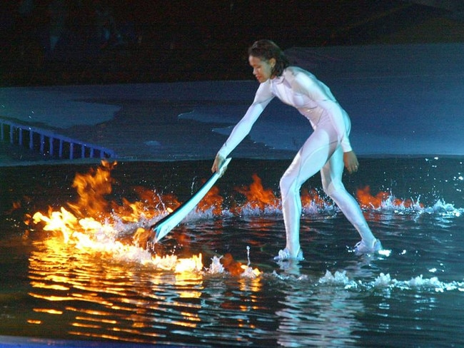 WIRE: Australian athlete Cathy Freeman lights the Olympic flame to complete the opening ceremony of the 2000 Sydney Olympic Games at Stadium Australia, Olympic Park, Homebush, Sydney 15/09/2000.