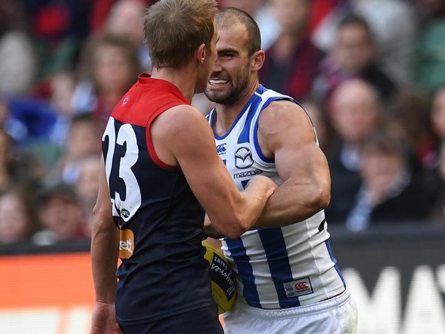 Ben Cunnington of the Kangaroos (right) punches Bernie Vince of the Demons in the stomach during the Round 9 AFL match between the Melbourne Demons and the North Melbourne Kangaroos at the MCG in Melbourne, Sunday, May 21, 2017. (AAP Image/Julian Smith) NO ARCHIVING, EDITORIAL USE ONLY