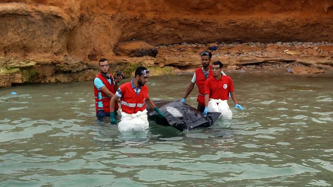 Members of the Libyan Red Crescent recover the body of a drowned migrant off the coast of Tajoura, east of the capital Tripoli, yesterday. Picture: AFP