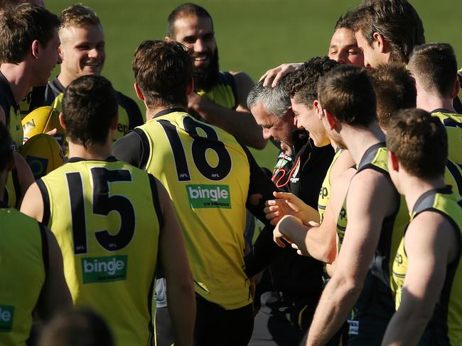 Mark Williams gets a cheer and pat on the head from Richmond players. Picture: Colleen Petch