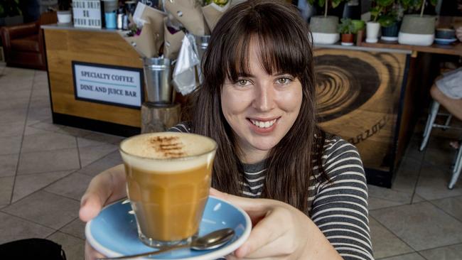 Gold Coast Bulletin journalist Amber Macpherson tries a Bulletproof coffee from Raw Espresso, Southport. Picture: Jerad Williams.