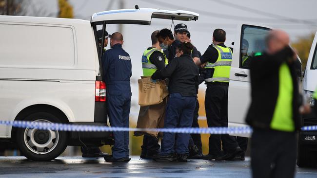 Forensic police remove evidence this morning. Picture: AAP