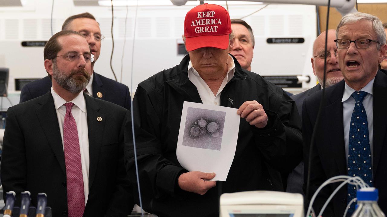 US President Donald Trump showing off his new hat and a picture of the coronavirus. Picture: Jim Watson / AFP