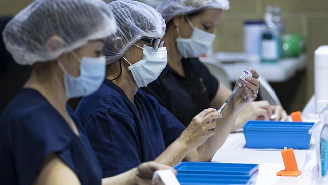 PERTH, AUSTRALIA - APRIL 28: Nurses are seen drawing up doses from a multi-dose vile of AstraZeneca Covid-19 vaccine at Claremont Showground on April 28, 2021 in Perth, Australia. The West Australian Government have opened up two new Vaccine Centres including one at Perth Airport. (Photo by Matt Jelonek/Getty Images)