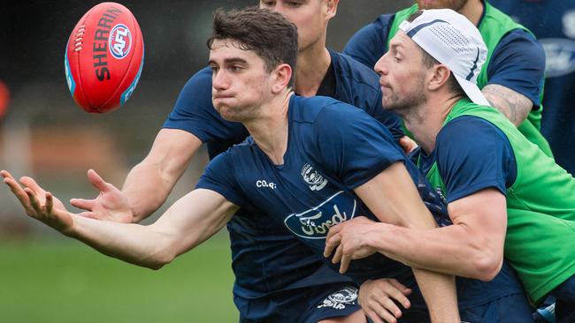 Mark O'Connor is tackled by Darcy Lang at Geelong training. Picture: Jay Town