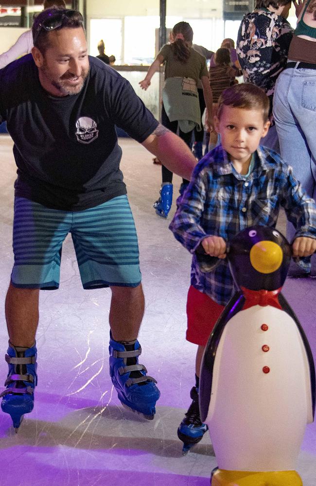 Six year old Kye Bell (right) skates with dad Travis Bell at the DFO ice skating rink. Photo: Brian Cassey