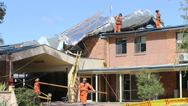 A large section of the roof was blown off the Presbyterian Aged Care facility at Stockton, north of Newcastle. SES workers battled to keep the remainder of roof in tact as the winds continue to strengthen. Picture by Peter Lorimer.