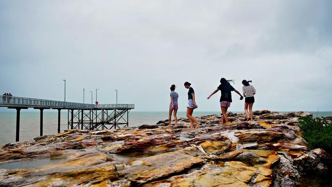 Teens at Nightcliff jetty enjoying the recent monsoonal weather.