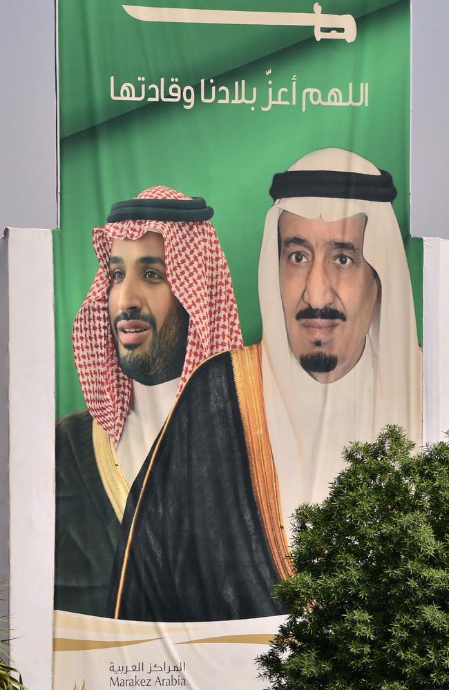 Portraits of Saudi King Salman bin Abdulazziz (R) and his son Crown Prince Mohammed bin Salman (MBS) are displayed in Riyadh.