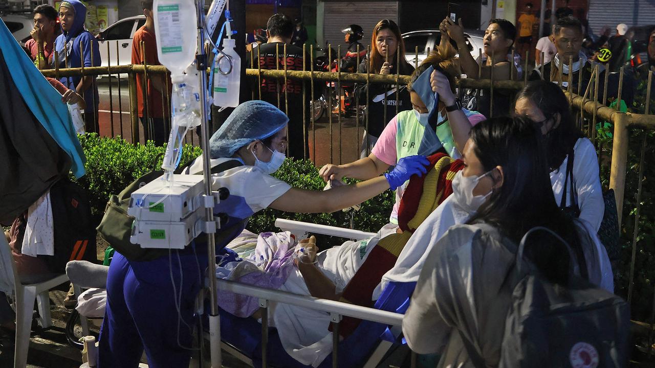 Residents and medical personnel evacuate patients from inside a hospital after a 7.6 earthquake struck Butuan City, in southern island of Mindanao. Picture: Ted Aljibe / AFP