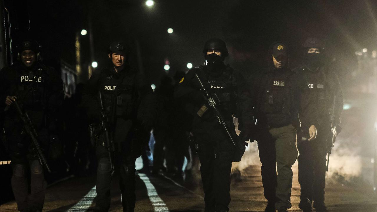 Law enforcement surround the building where the Crumbleys were arrested. Picture: Matthew Hatcher/Getty Images/AFP