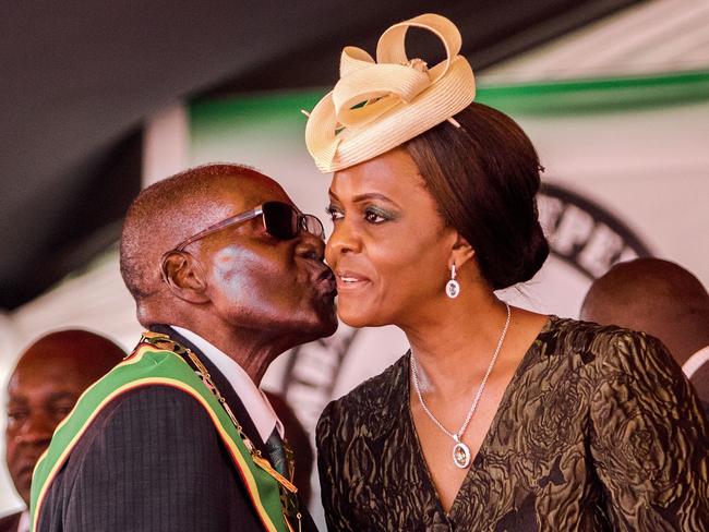 Robert Mugabe kisses his wife and first lady Grace during the country’s 37th Independence Day celebrations in April. Picture: Jekesai Njikizana/AFP