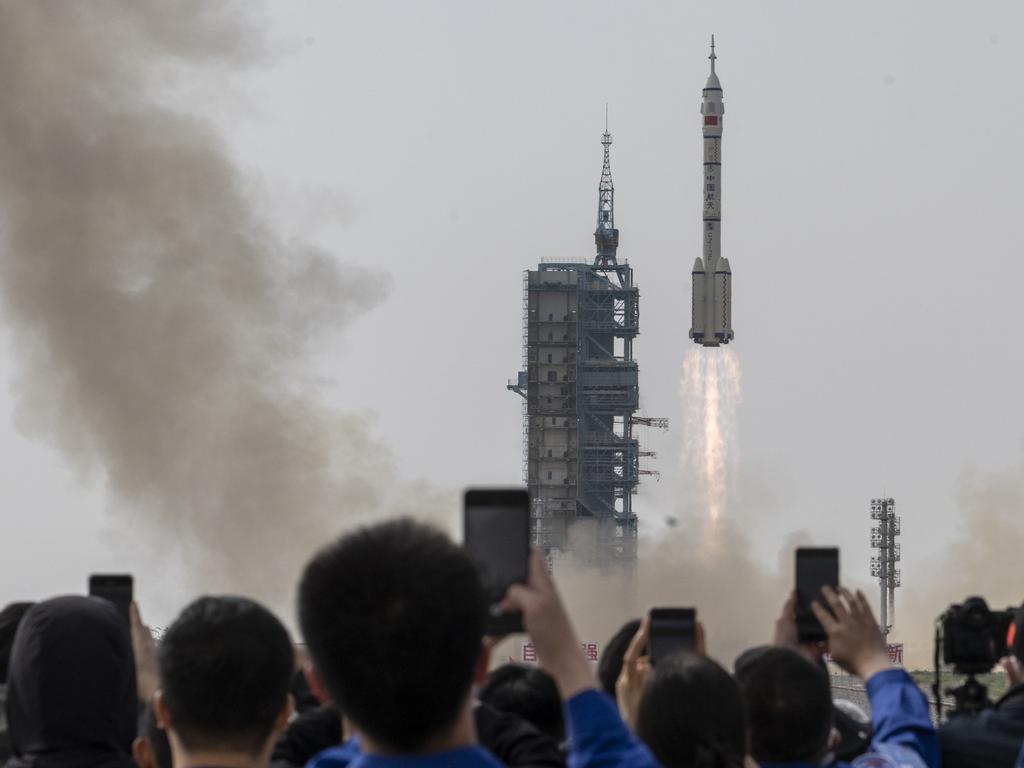 Members from China's Manned Space Agency and visitors watch as the Shenzhou-16 spacecraft rocket launches at the Jiuquan Satellite Launch Center. Picture: Getty Images