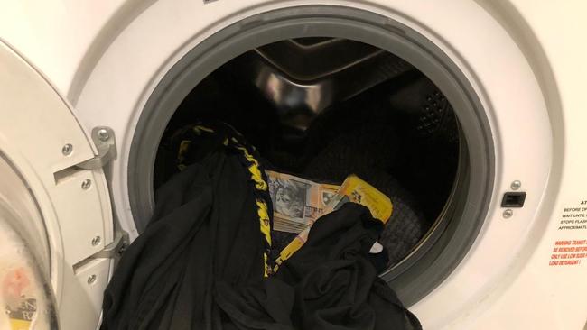 Cash allegedly found in a washing machine at the home of Robina woman Hannah Christie Lovejoy. Picture: AFP.