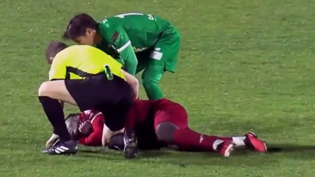 Adelaide United's Nestory Irankunda tripped over and fell awkwardly to the ground, clutching his throat. Referee Dr Christian Verdicchio quickly used his expertise to ensure the player didn't swallow this tongue. Picture: Supplied