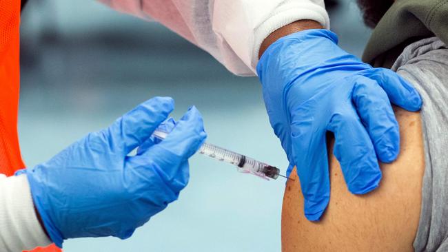 On January 10, 2021, a man receives a dose of the Moderna Covid-19 vaccine at a vaccination site at South Bronx Educational Campus, in New York. Picture: Getty