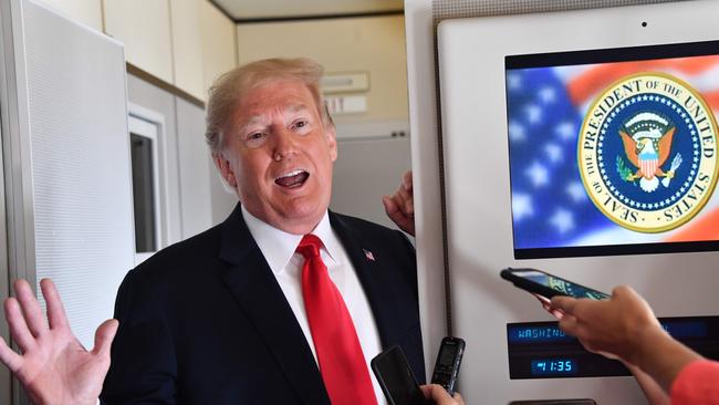 US President Donald Trump speaks to the press aboard Air Force One on Friday. Picture: AFP