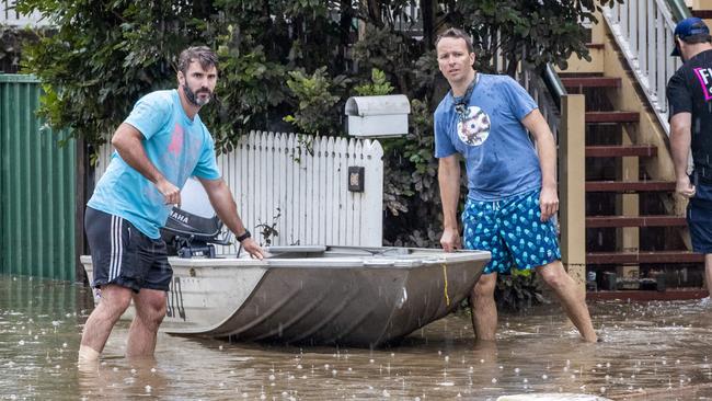 Volunteers Andrew Brady (left) and Tim Bryant (right) with their dinghy. Picture: Richard Walker