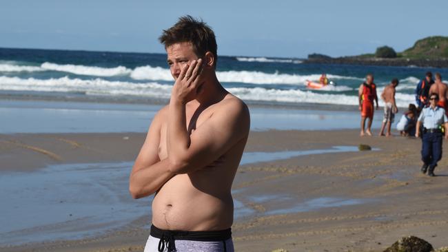 A distressed beachgoer at Fingal Head yesterday.