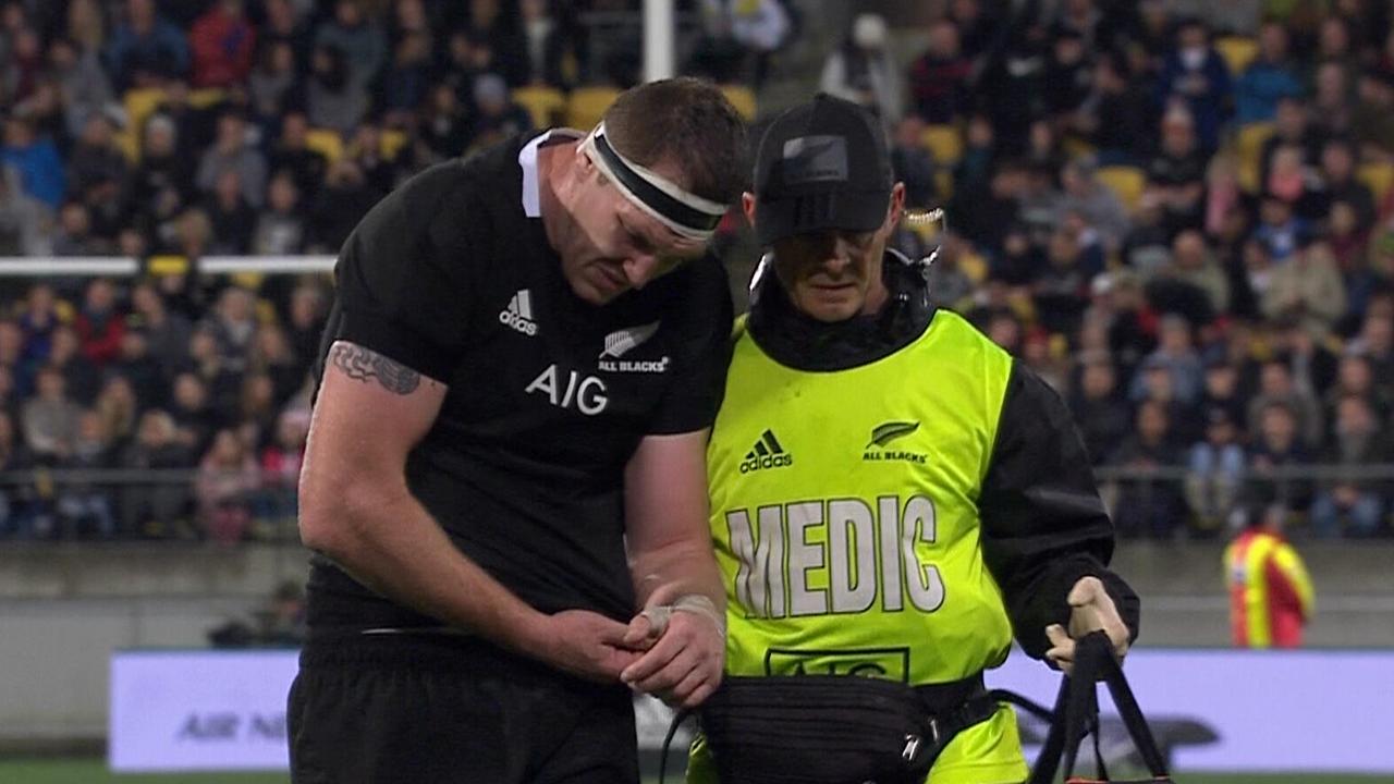 Brodie Retallick cradles his left-arm as he is assisted off the field.