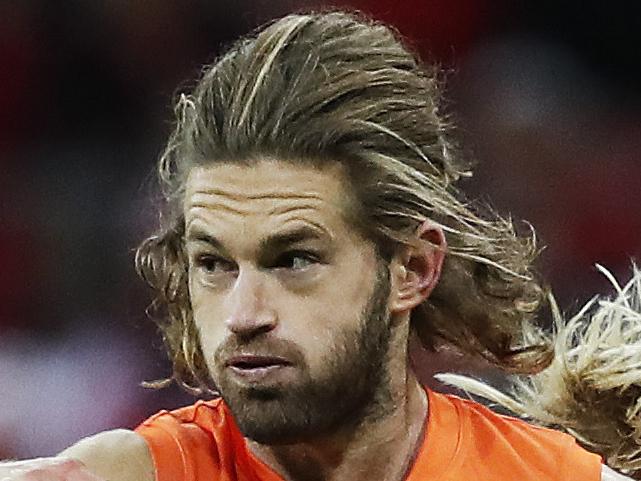 Giants Callan Ward kicks under pressure from Sydney's Isaac Heeney during AFL match GWS Giants v Sydney Swans at Spotless Stadium. Picture. Phil Hillyard