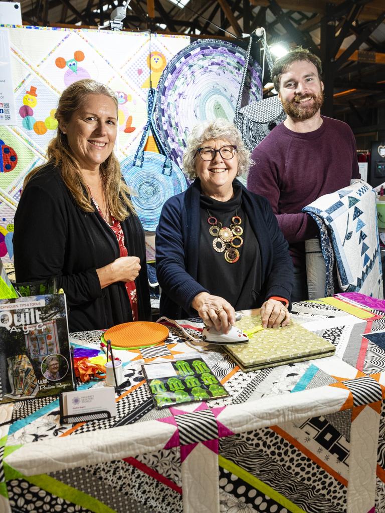 Pauline Rogers (centre) of Cabarlah's Pauline's Quilters World demonstrates sasher collection tools with Jo Cantly and Simon Pratt at Craft Alive at the Goods Shed, Saturday, May 21, 2022. Picture: Kevin Farmer