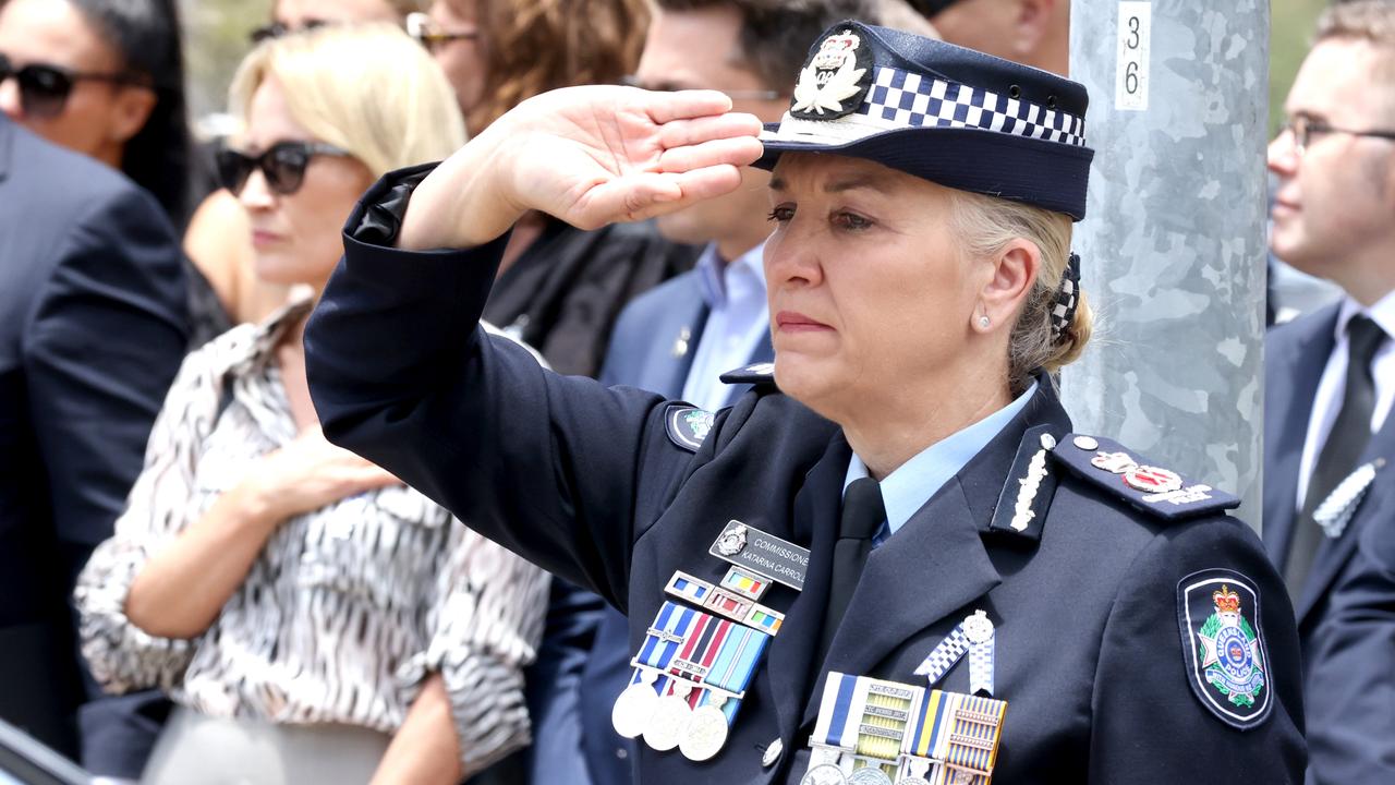 Commissioner Katarina Carroll salutes the coffins of Constable Matthew Arnold and Constable Rachel McCrow at their memorial service. – Photo Steve Pohlner