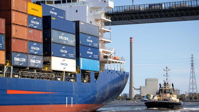 MELBOURNE, DECEMBER 9, 2022: Tour of AustraliaÃs largest container and general cargo port, the Port of Melbourne. A Svitzer tug boat follows a container ship under the West Gate Bridge. Picture: Mark Stewart