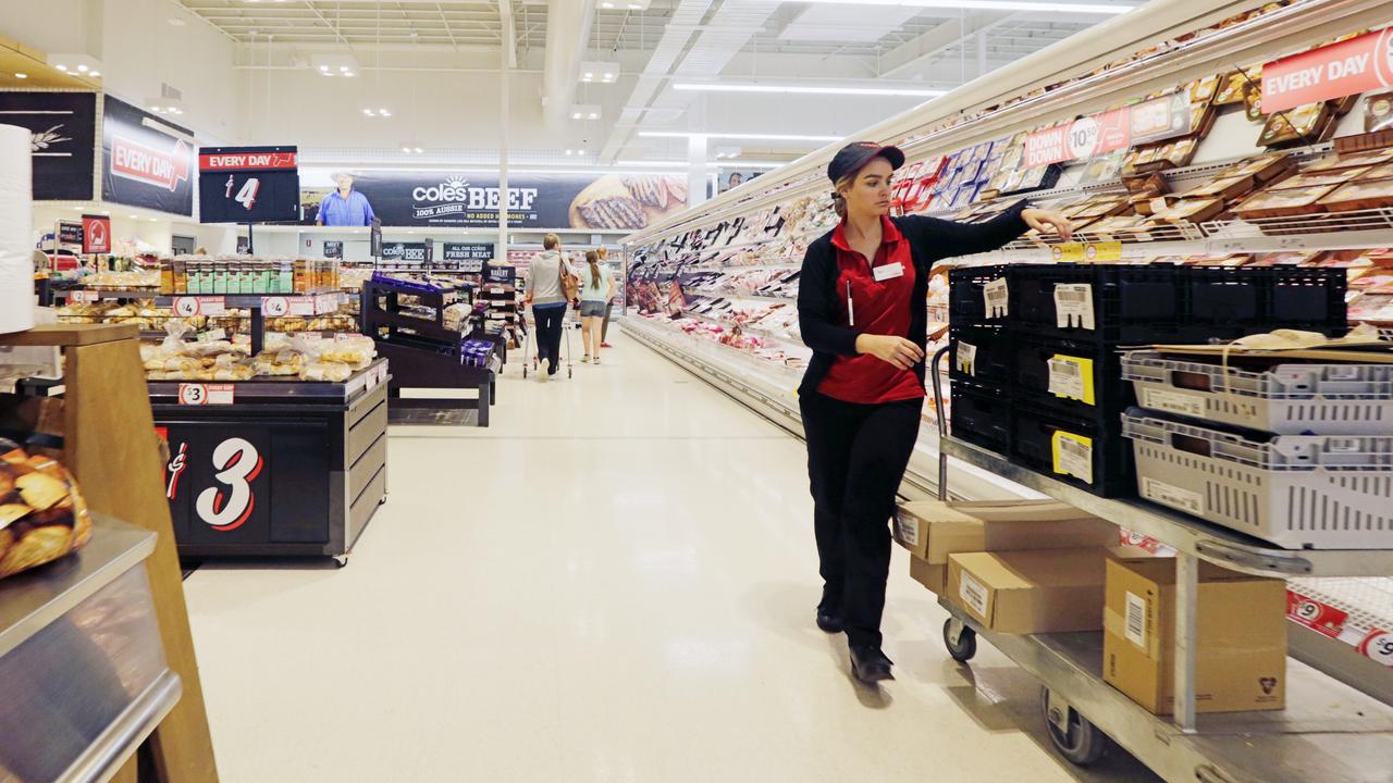 A worker stacking shelves at Coles.