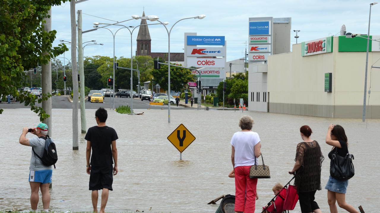 Locals watch as flood waters rise in Bundaberg, on January 28, 2013.