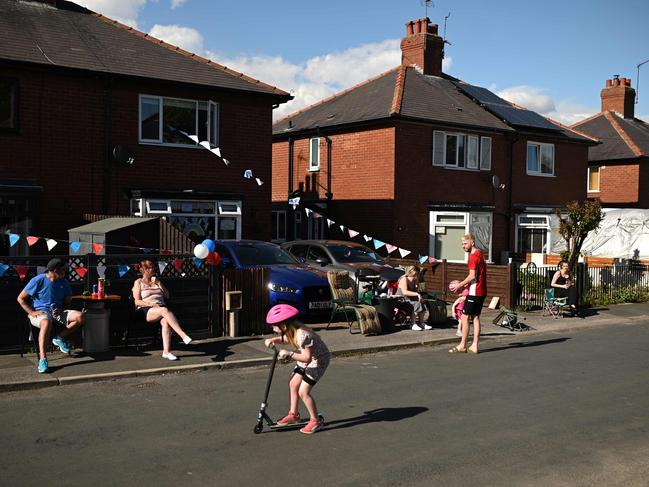 Residents observe social distancing as they attend a street party to mark the 75th anniversary of VE Day. Picture: AFP