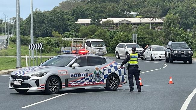 Police direct traffic after from a serious two-vehicle highway crash that also resulted in a vehicle fire at Glenella. Photo: Janessa Ekert