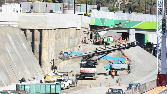 Workers fixing collapsed sections of shotcrete wall on a lowered section of the new motorway at Darlington. Picture: Brenton Edwards