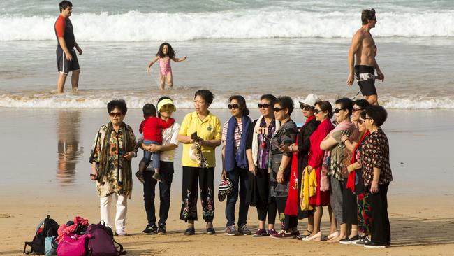 Tourists pose for pictures on Manly Beach, pre-pandemic. Picture: Damian Shaw