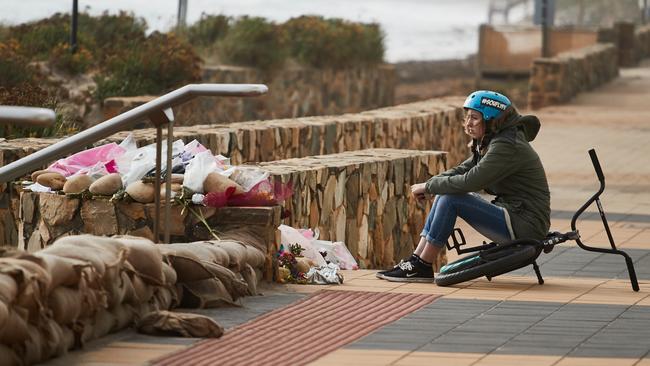 Libby Bell’s friend Blayze looking to the beach at Lybby’s shrine at the Moana Surf Life Saving Club in Moana. AAP Image/MATT LOXTON