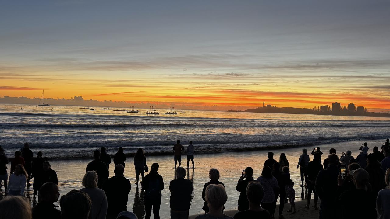 Moloolaba Surf Boats in a raised oar salute as part of the dawn service at Anzac Day 2024 at Mooloolaba which was attended by about 5000 people. Photo: Mark Furler